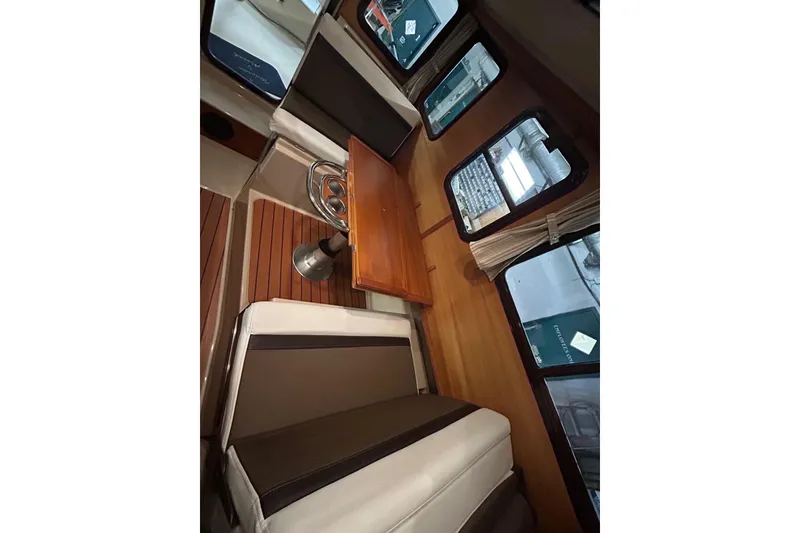Slide: The Image of 2017 Ranger Tugs R-25 SC interior with seating and wooden table. - 15