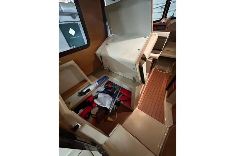 Slide: The Image of 2017 Ranger Tugs R-25 SC interior storage compartment with life jackets and equipment. - 16