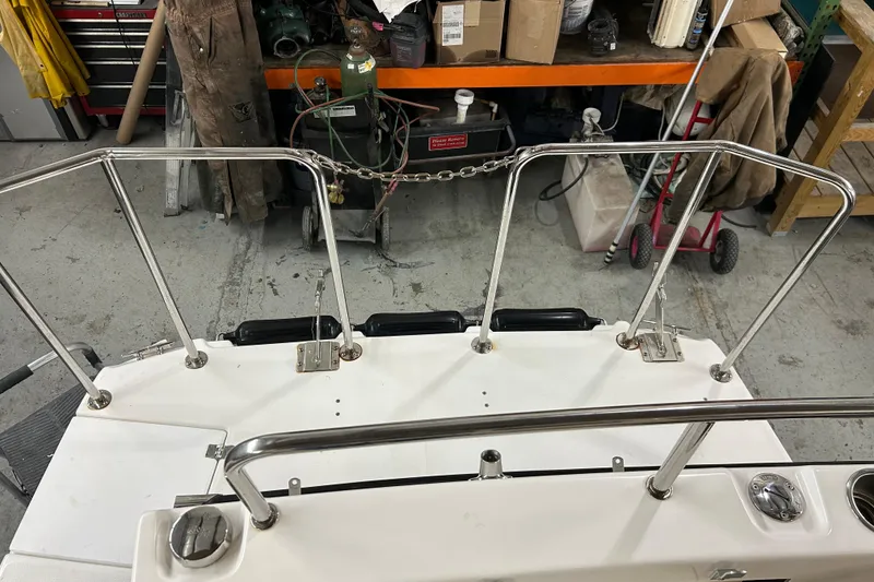 Slide: The Image of 2017 Ranger Tugs R-25 SC boat deck with stainless steel railings in a workshop. - 6