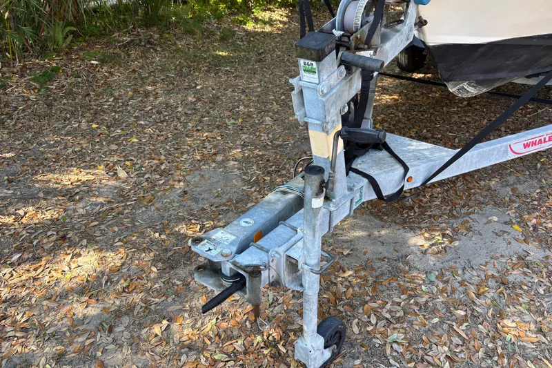 Slide: The Image of Trailer hitch of a 2015 Boston Whaler 190 Outrage boat on leaf-covered ground. - 10