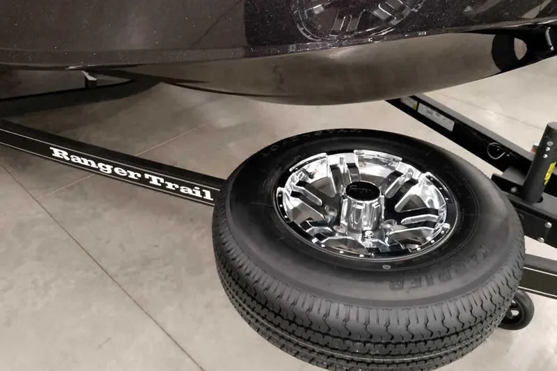 Slide: The Image of 2026 Ranger 1880MS Angler trailer with chrome wheel and tire detail. - 13