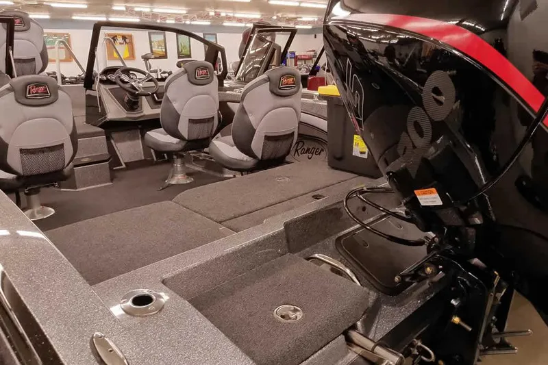 Slide: The Image of 2026 Ranger 1880MS Angler boat interior with seating and motor detail. - 6