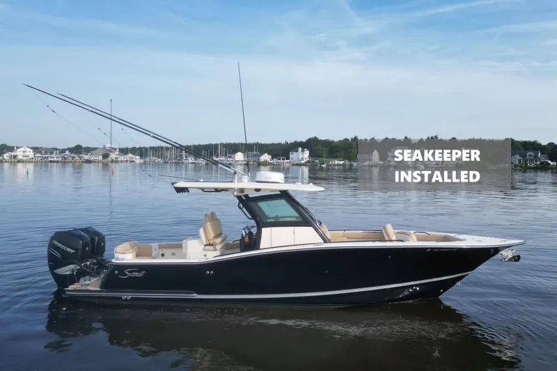 The Image of 2021 Scout 305 LXF boat with Seakeeper installed, docked on calm water. - 0