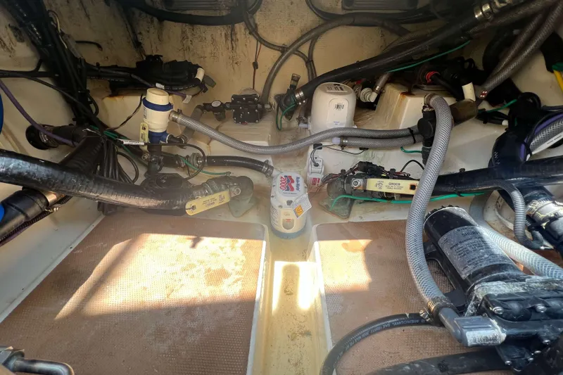 Slide: The Image of 2021 Scout 305 LXF boat interior showing engine compartment and wiring. - 10