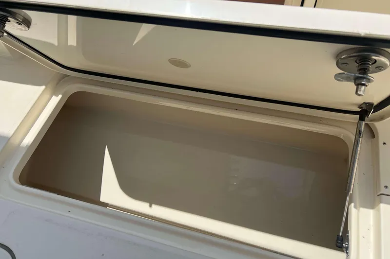 Slide: The Image of Open storage compartment on a 2021 Scout 305 LXF boat. - 12