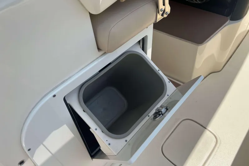 Slide: The Image of 2021 Scout 305 LXF boat storage compartment with open lid, showcasing interior space. - 15