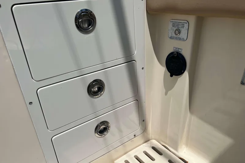Slide: The Image of 2021 Scout 305 LXF boat storage compartments and raw water washdown. - 19