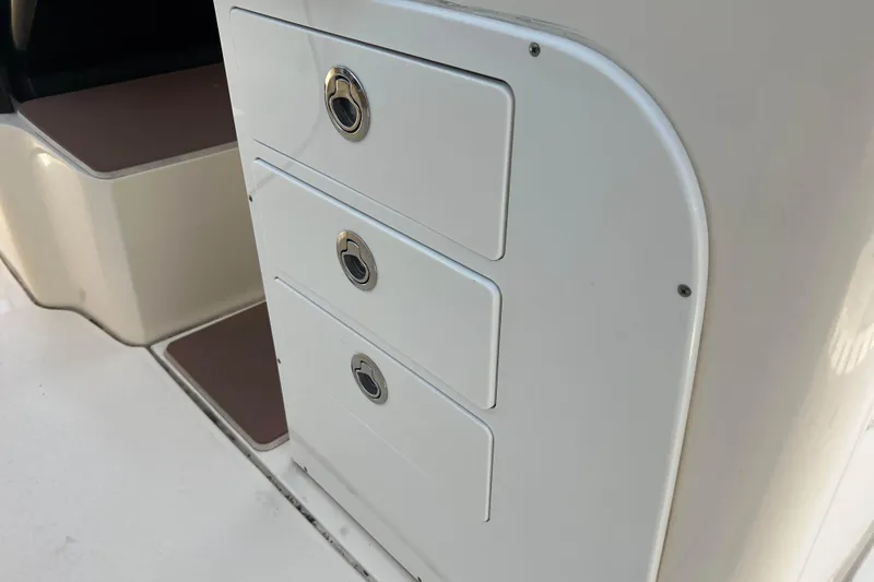 Slide: The Image of 2021 Scout 305 LXF boat interior storage drawers. - 22
