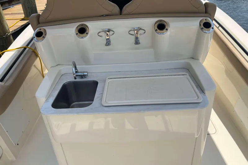 Slide: The Image of 2021 Scout 305 LXF boat sink and prep station with rod holders. - 24