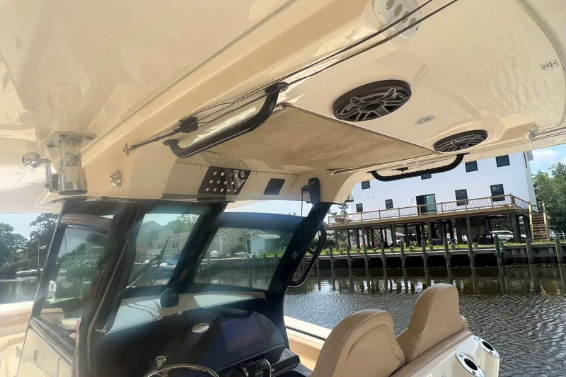 Slide: The Image of 2021 Scout 305 LXF boat interior with speakers and control panel. - 28