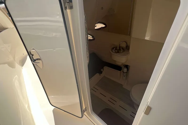 Slide: The Image of 2021 Scout 305 LXF boat interior with compact bathroom amenities. - 36