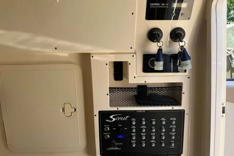 Slide: The Image of Control panel of a 2021 Scout 305 LXF boat with switches and solar charge controller. - 39