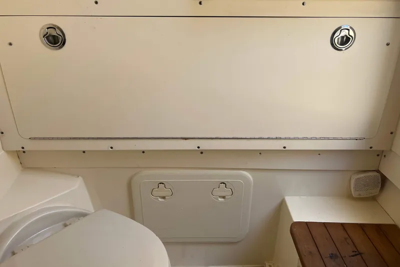 Slide: The Image of 2021 Scout 305 LXF boat interior storage compartments and seating area. - 42