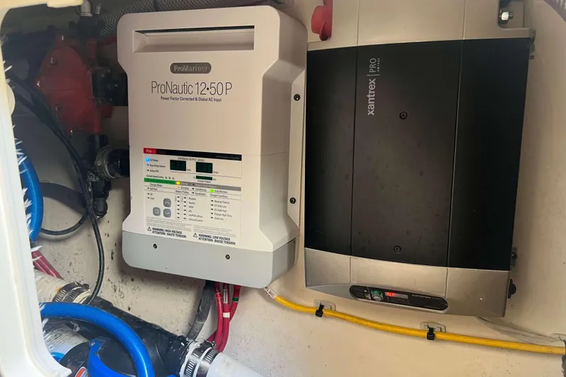 Slide: The Image of Electrical components inside a 2021 Scout 305 LXF boat, featuring ProNautic and Xantrex systems. - 45