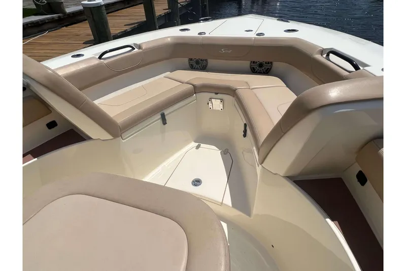 Slide: The Image of 2021 Scout 305 LXF boat interior with beige seating and deck view. - 50