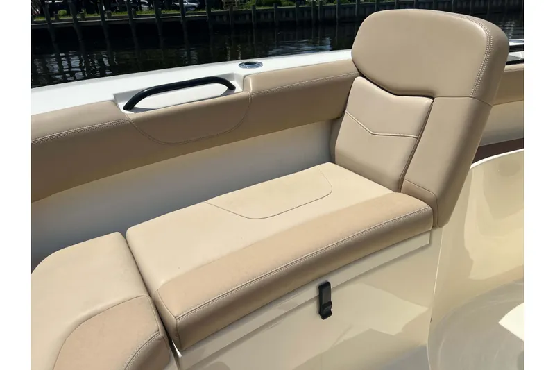 Slide: The Image of 2021 Scout 305 LXF boat with beige cushioned seating and sleek design. - 51