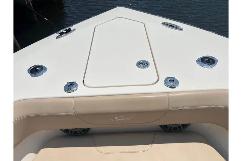 Slide: The Image of 2021 Scout 305 LXF boat bow with beige seating and storage compartment. - 53