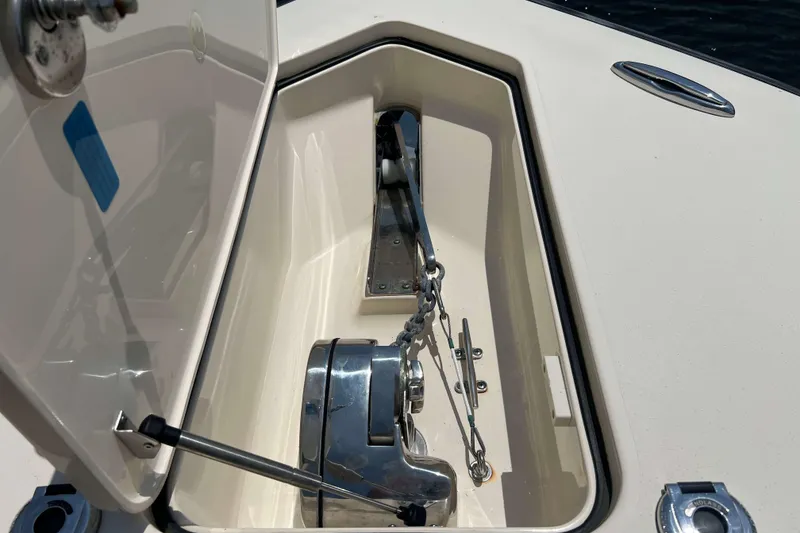 Slide: The Image of Anchor compartment of 2021 Scout 305 LXF boat with chain and winch. - 54