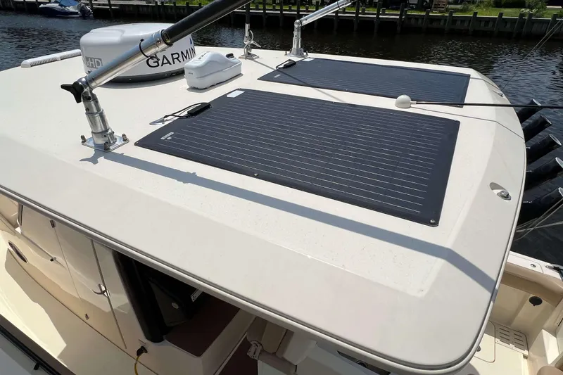 Slide: The Image of 2021 Scout 305 LXF boat with solar panels and Garmin equipment on deck. - 63