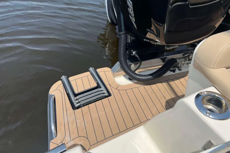 Slide: The Image of 2021 Scout 305 LXF boat with teak swim platform and retractable ladder. - 64