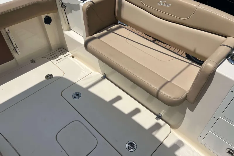 Slide: The Image of 2021 Scout 305 LXF boat interior with beige seating and deck details. - 7