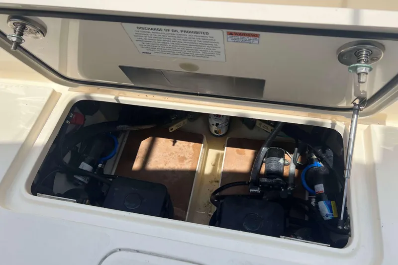 Slide: The Image of Open hatch of 2021 Scout 305 LXF boat showing internal components and wiring. - 9