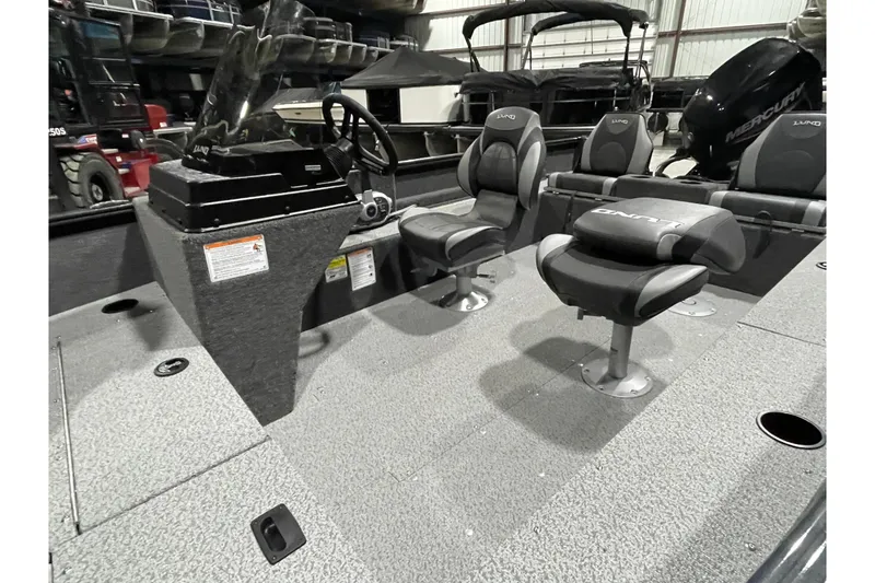 Slide: The Image of 2026 Lund 1650 Rebel XL SS boat interior with seating and steering console. - 10