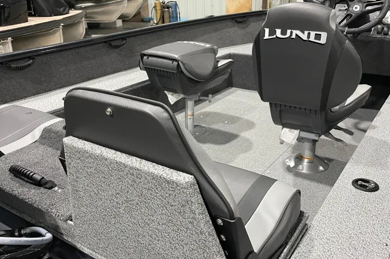 Slide: The Image of 2026 Lund 1650 Rebel XL SS boat interior with seating and steering console. - 3