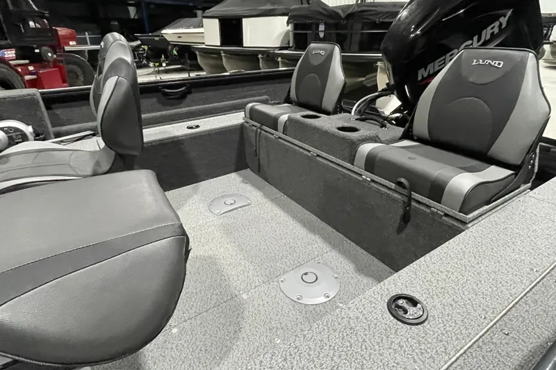Slide: The Image of 2026 Lund 1650 Rebel XL SS boat interior with gray seating and Mercury engine. - 5