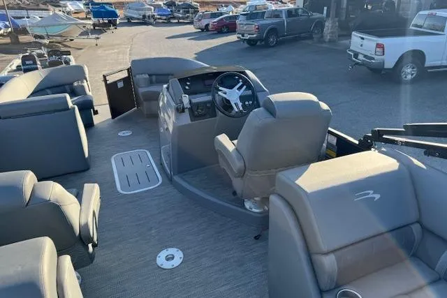 Slide: The Image of 2022 Bennington 23LFB pontoon boat interior with steering console and seating. - 11