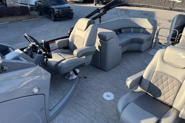 Slide: The Image of 2022 Bennington 23LFB pontoon boat interior with gray seating and steering console. - 14