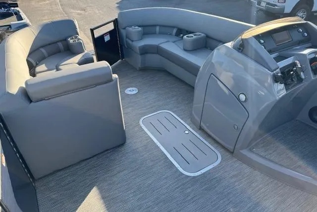 Slide: The Image of 2022 Bennington 23LFB boat interior with gray seating and modern dashboard. - 15