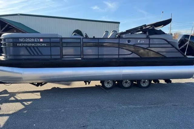 Slide: The Image of 2022 Bennington 23LFB pontoon boat on trailer, parked outdoors. - 3