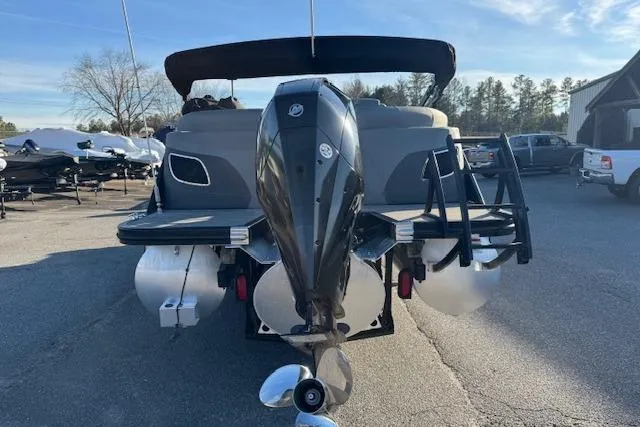Slide: The Image of 2022 Bennington 23LFB pontoon boat with outboard motor, parked outdoors. - 5