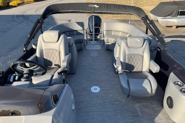 Slide: The Image of 2022 Bennington 23LFB pontoon boat interior with plush seating and steering console. - 9