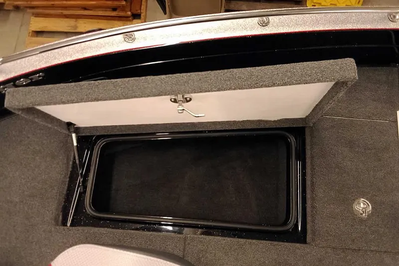 Slide: The Image of 2026 Ranger 621FS Fisherman boat storage compartment with open lid, showcasing interior space. - 11