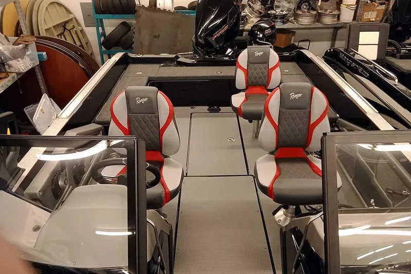 Slide: The Image of 2026 Ranger 621FS Fisherman boat interior with three stylish seats in a showroom. - 17