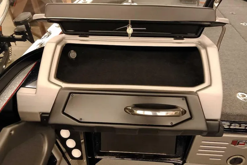 Slide: The Image of 2026 Ranger 621FS Fisherman boat dashboard with storage compartment and key. - 18