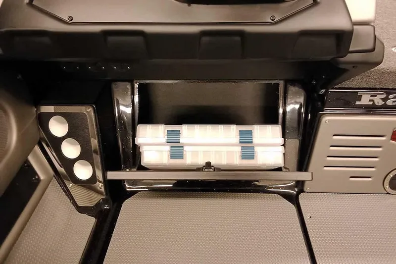 Slide: The Image of 2026 Ranger 621FS Fisherman boat storage compartment with tackle box. - 19