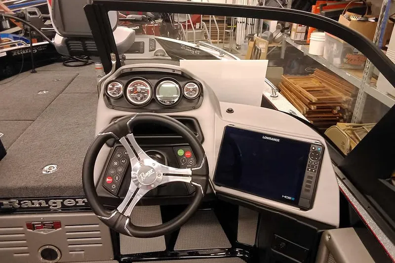 Slide: The Image of 2026 Ranger 621FS Fisherman boat dashboard with steering wheel and Lowrance display. - 21