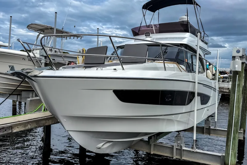 The Image of 2022 Beneteau Antares 11 Fly yacht docked at marina under cloudy sky. - 0