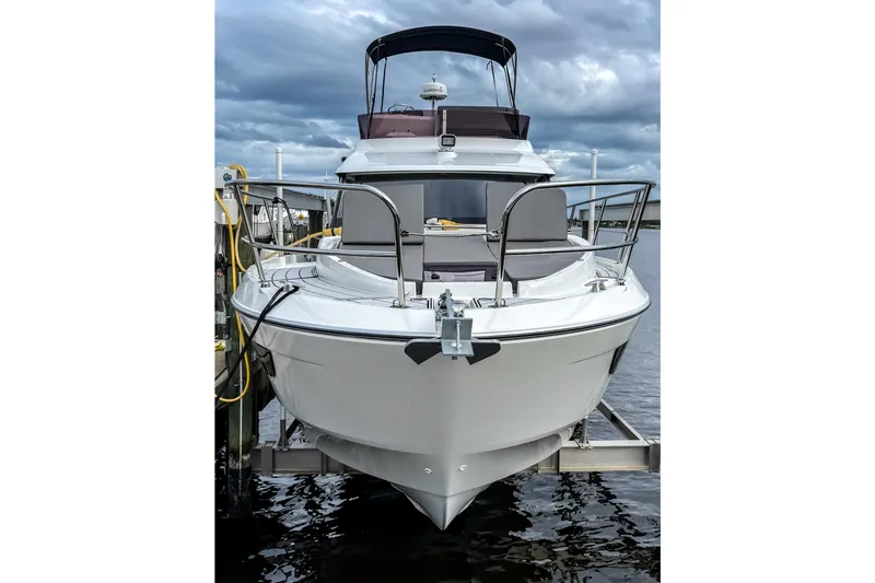 Slide: The Image of 2022 Beneteau Antares 11 Fly yacht docked under cloudy skies. - 1