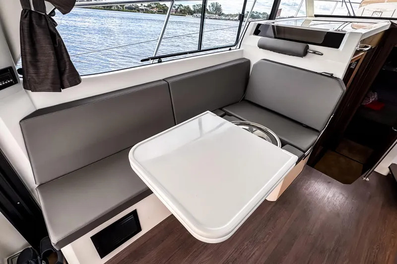 Slide: The Image of Interior of 2022 Beneteau Antares 11 Fly with sleek seating and table setup. - 10
