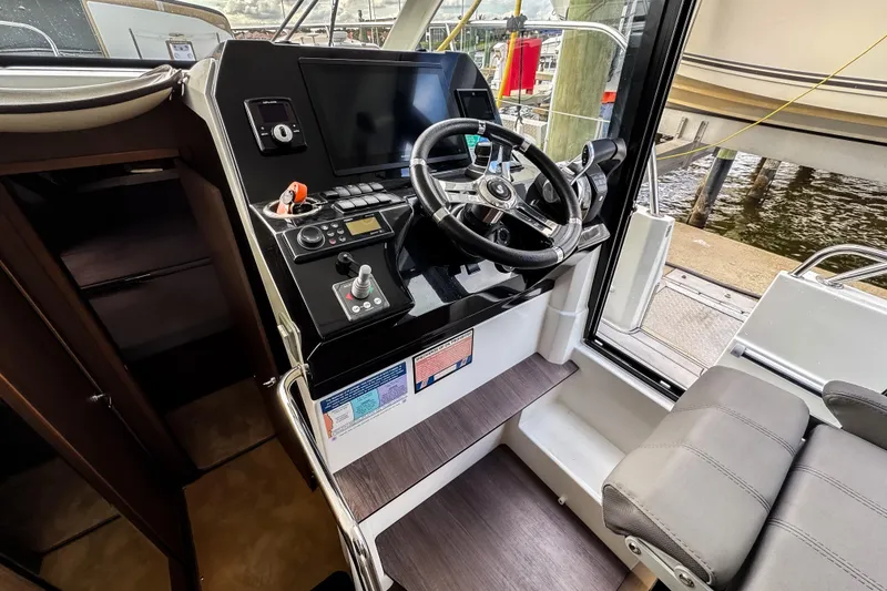 Slide: The Image of 2022 Beneteau Antares 11 Fly helm with modern controls and navigation display. - 12