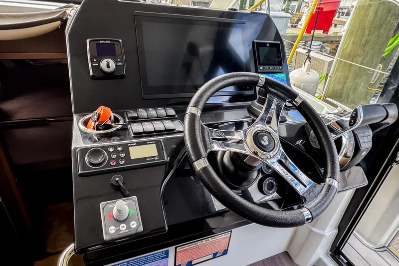 Slide: The Image of Helm of 2022 Beneteau Antares 11 Fly with modern controls and navigation equipment. - 13