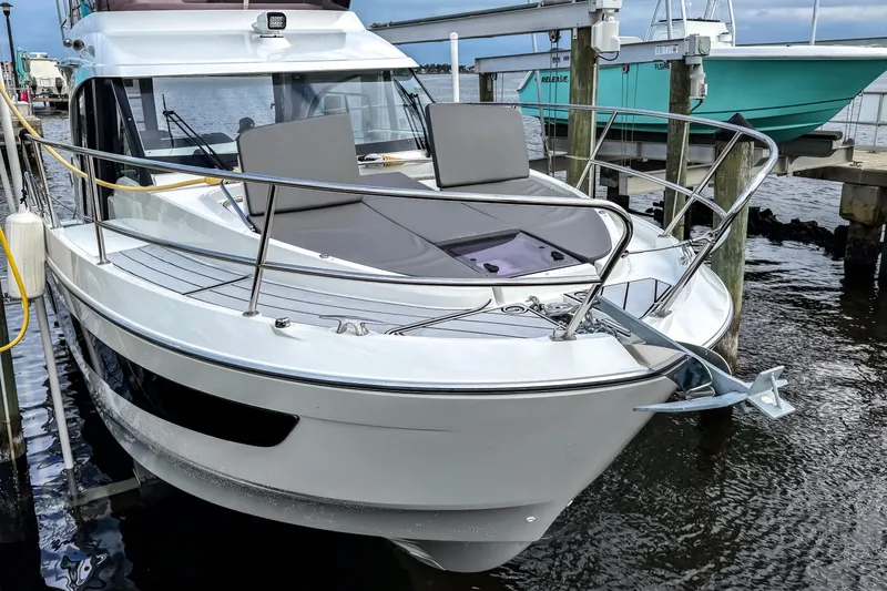Slide: The Image of 2022 Beneteau Antares 11 Fly yacht docked at marina, front view. - 2