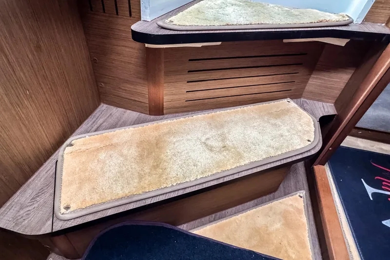 Slide: The Image of Wooden interior stairs with beige carpet in 2022 Beneteau Antares 11 Fly. - 21