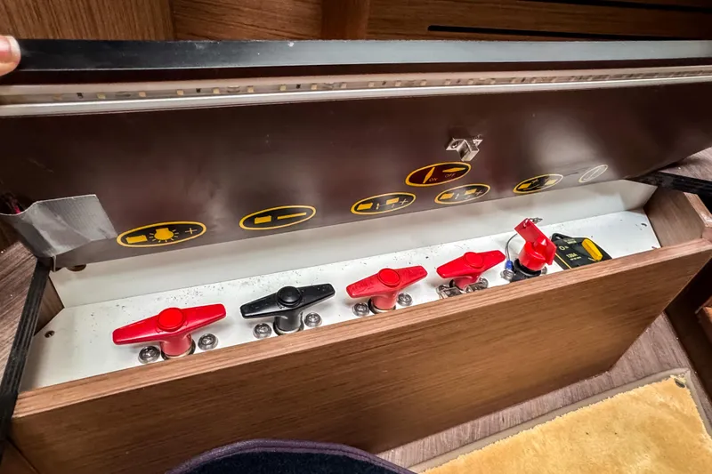 Slide: The Image of Control panel of a 2022 Beneteau Antares 11 Fly boat with labeled switches. - 22