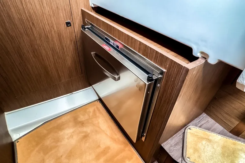 Slide: The Image of Interior of 2022 Beneteau Antares 11 Fly with compact stainless steel fridge. - 26