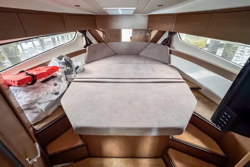 Slide: The Image of 2022 Beneteau Antares 11 Fly cabin interior with bed and life jacket. - 31